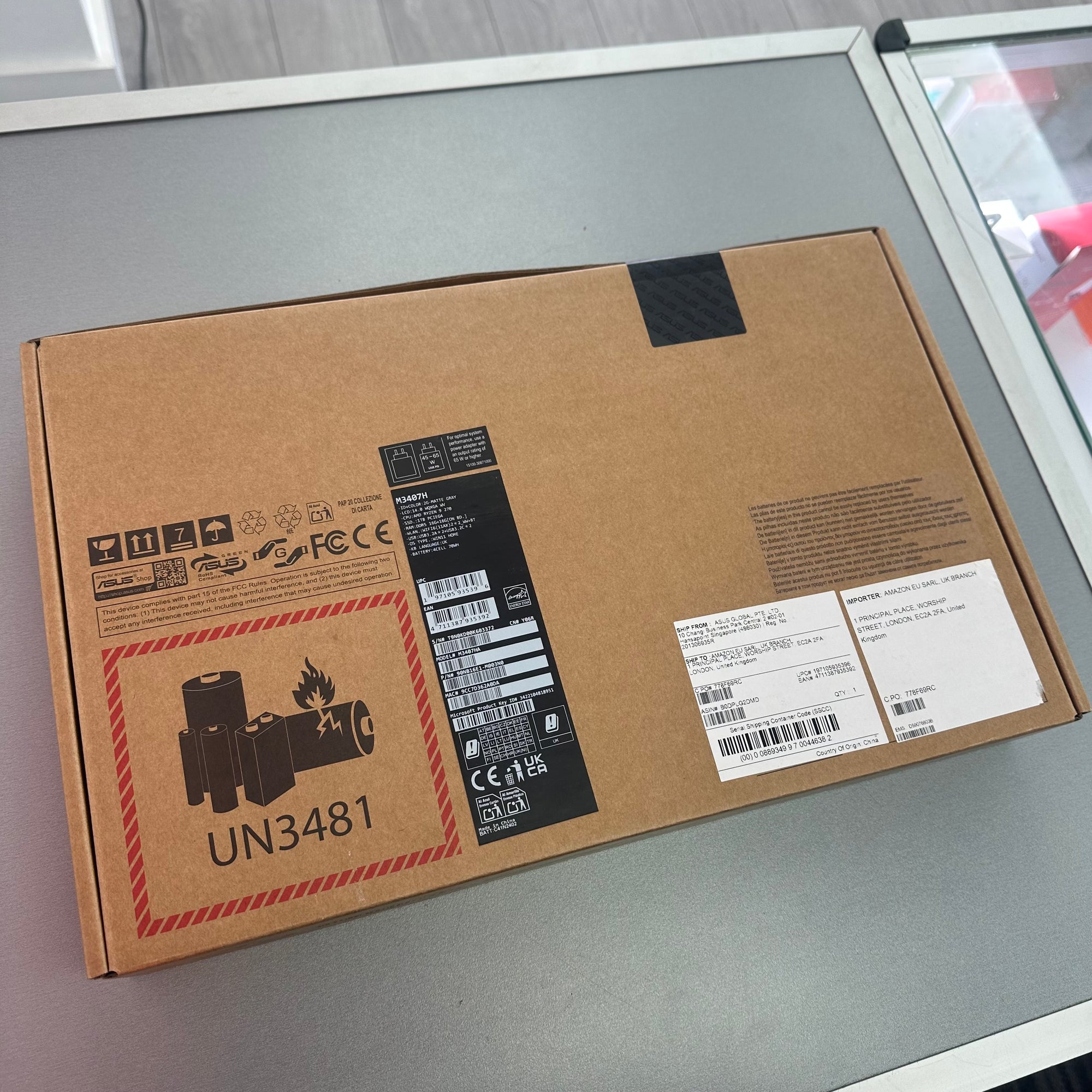 Cardboard box with labels on a gray surface