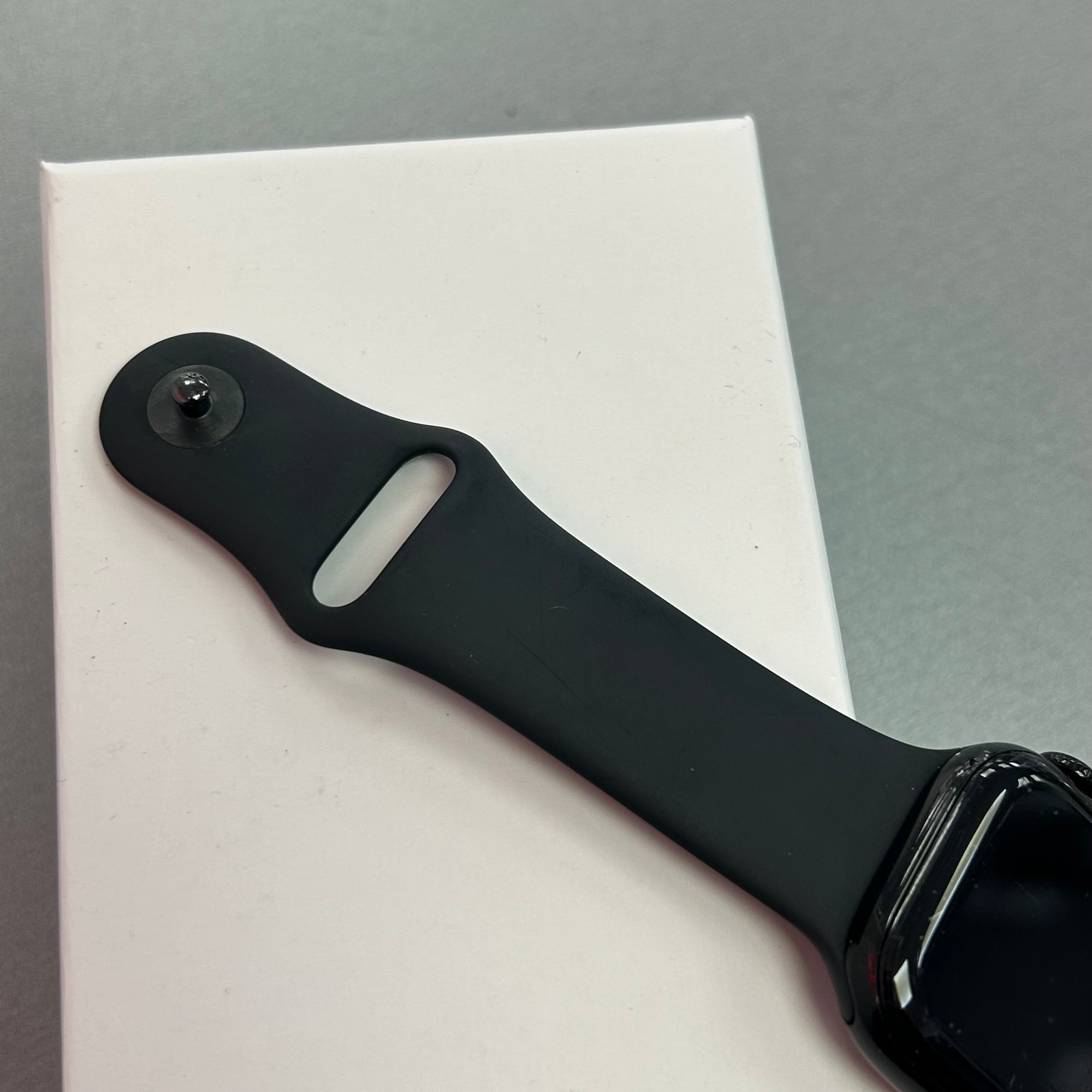 Black watch strap on a white and gray background