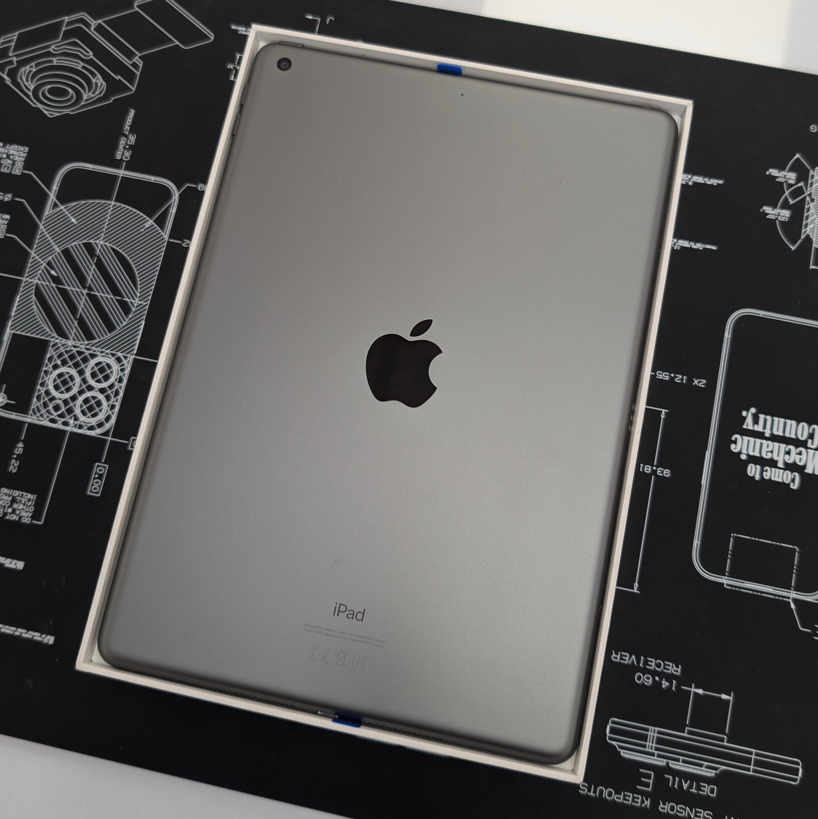 Apple iPad on a technical drawing background