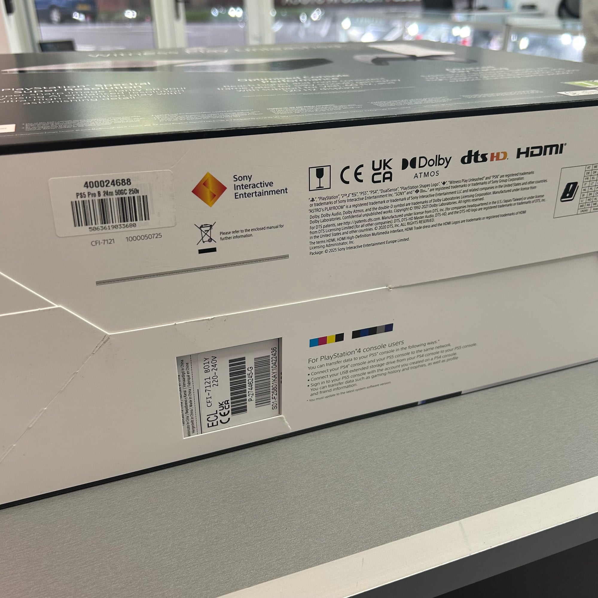 Close-up of a Sony gaming console box with labels and logos.