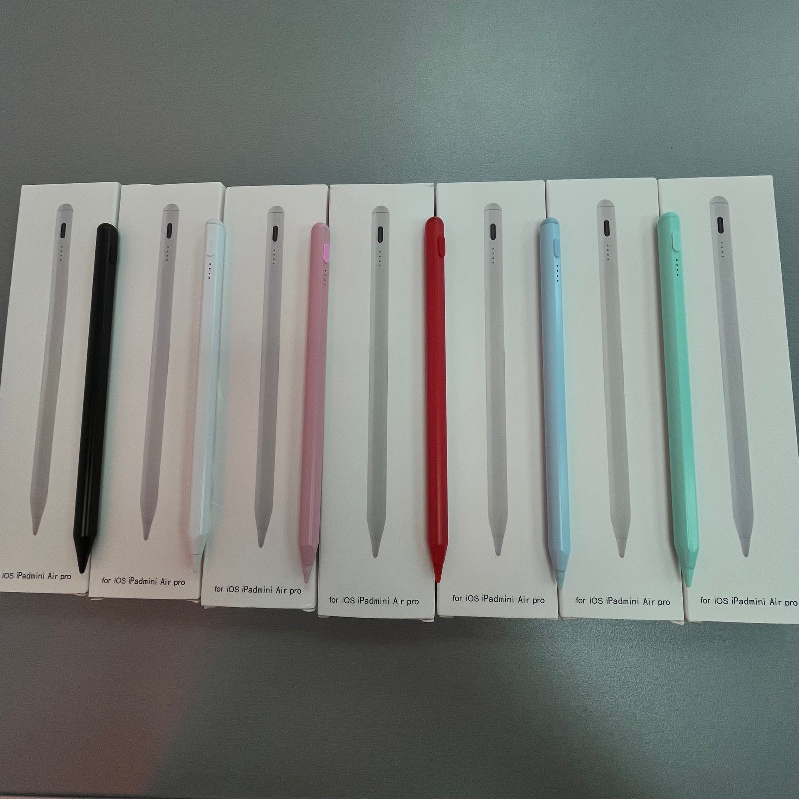 A set of stylus pens for Apple iPads, displayed in a row with different colors including black, white, pink, red, and blue.