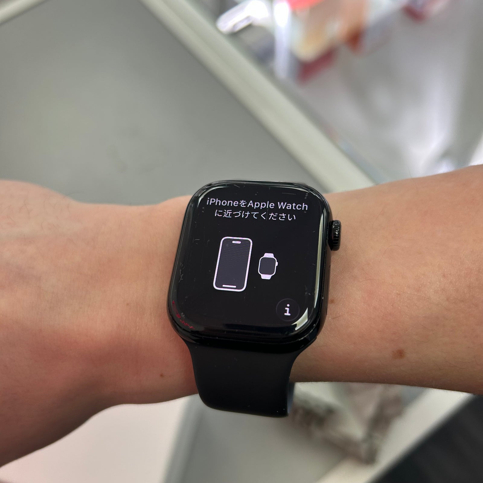 Black apple series 10 smartwatch on a wrist with a screen displaying text and icons.