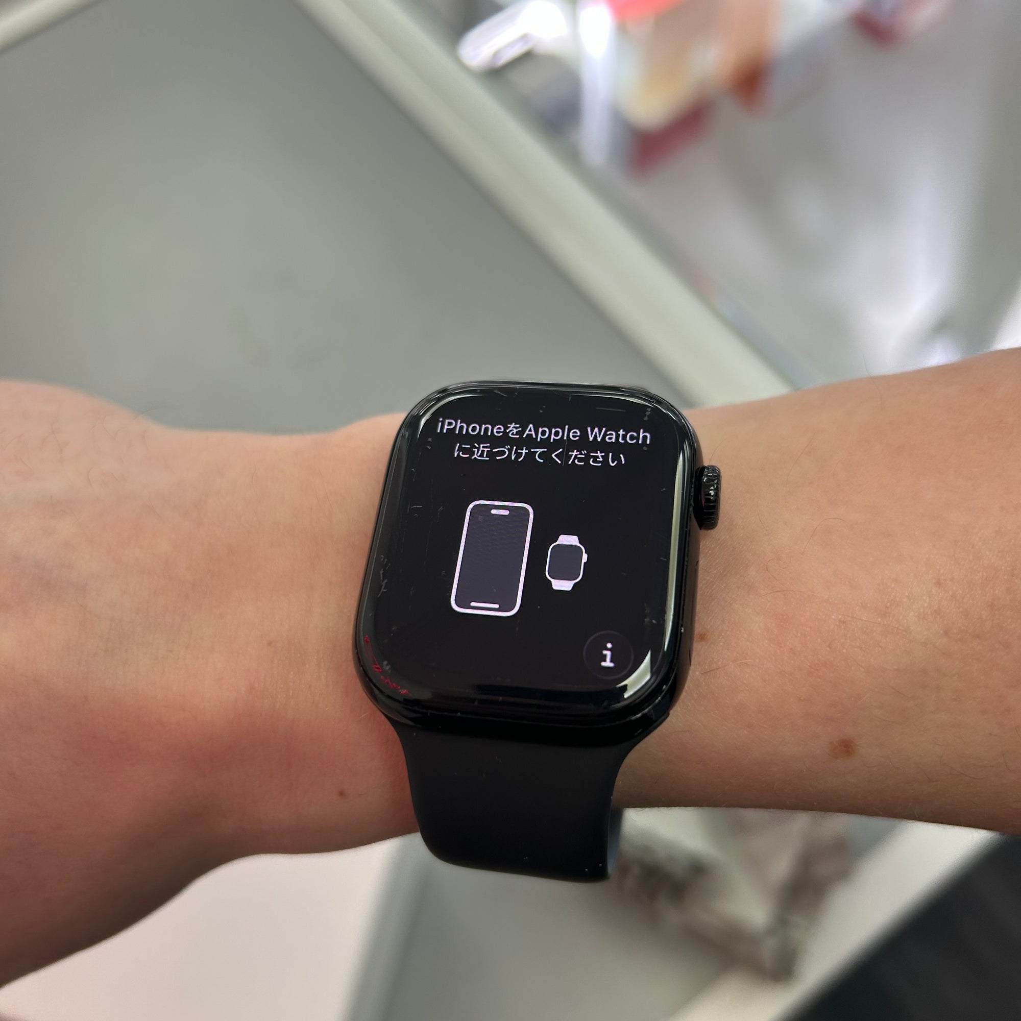Black apple series 10 smartwatch on a wrist with a screen displaying text and icons.